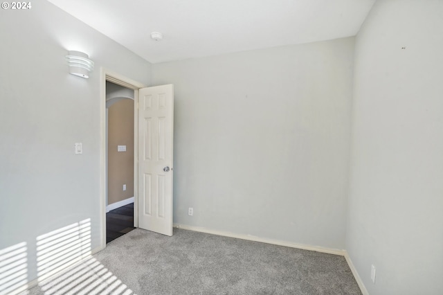 empty room featuring light colored carpet