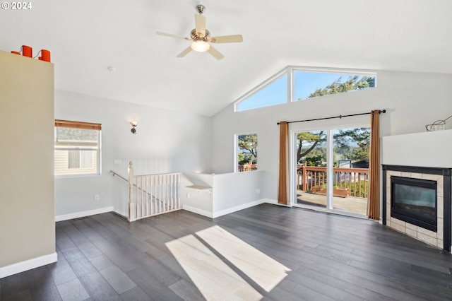 unfurnished living room featuring a fireplace, lofted ceiling, ceiling fan, and dark wood-type flooring