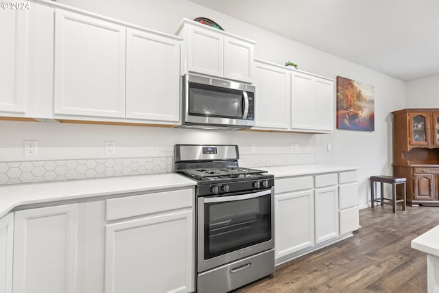 kitchen featuring stainless steel appliances, white cabinets, and dark hardwood / wood-style flooring