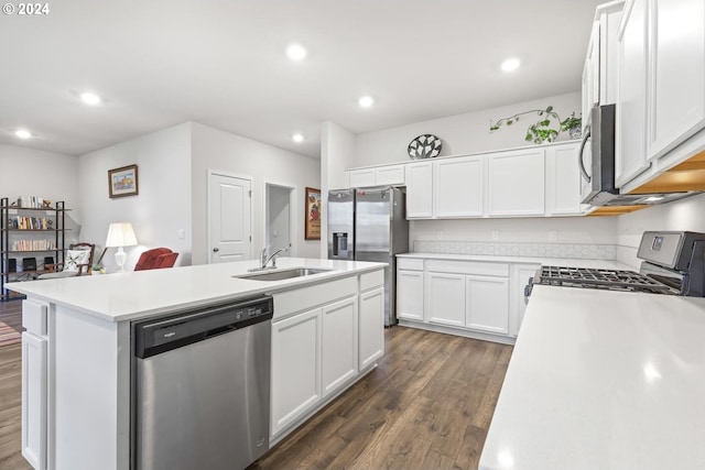 kitchen with sink, a kitchen island with sink, dark hardwood / wood-style floors, white cabinetry, and appliances with stainless steel finishes