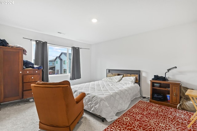 bedroom featuring light colored carpet