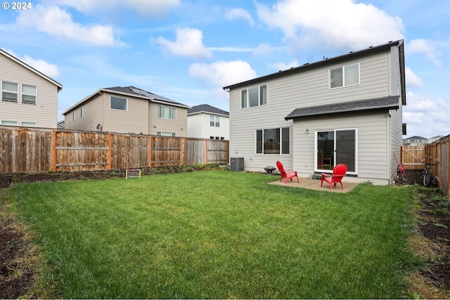 rear view of property with central AC unit, a lawn, and a patio