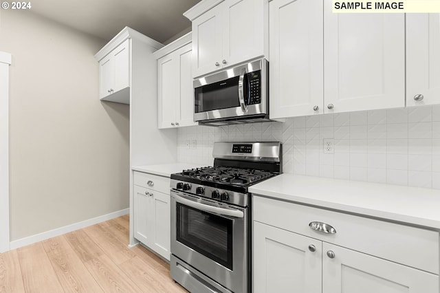 kitchen featuring light hardwood / wood-style floors, white cabinetry, backsplash, and appliances with stainless steel finishes