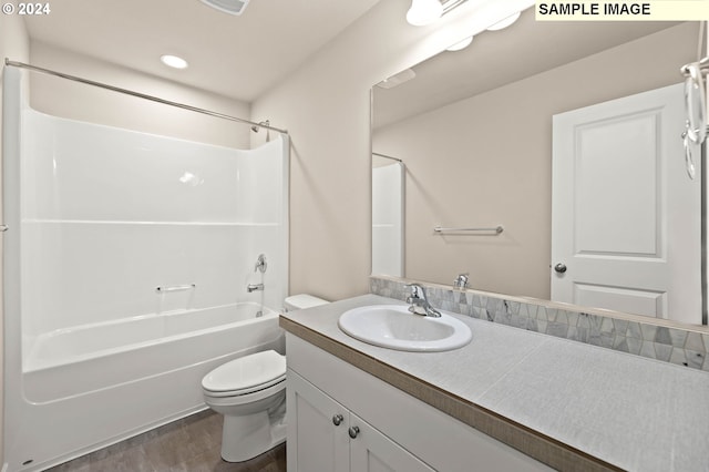 full bathroom with vanity, toilet, wood-type flooring, and tub / shower combination