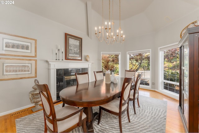 317 Aker Dr, Myrtle Creek, OR 97457 - dining area with a chandelier, baseboards, light wood-style flooring, and vaulted ceiling