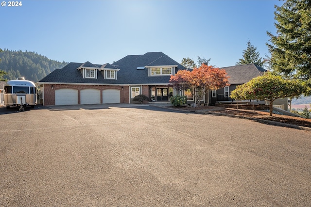 view of front of property featuring a mountain view and a garage