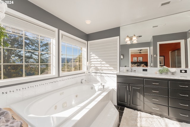 317 Aker Dr, Myrtle Creek, OR 97457 - ensuite bathroom featuring vanity, a jetted tub, and tile patterned flooring