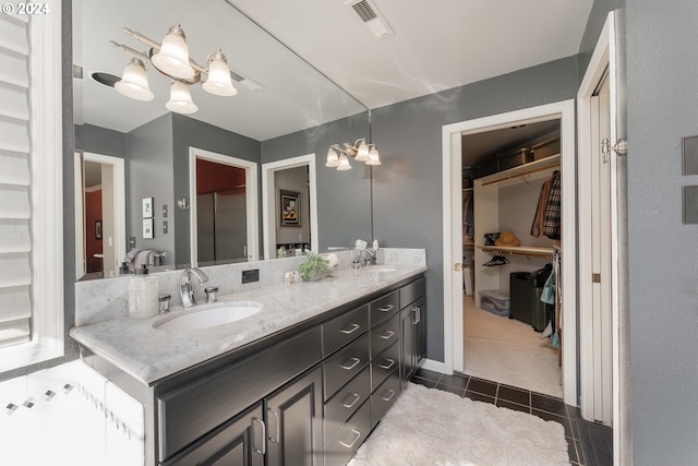 317 Aker Dr, Myrtle Creek, OR 97457 - bathroom featuring tile patterned flooring, double vanity, and a spacious closet