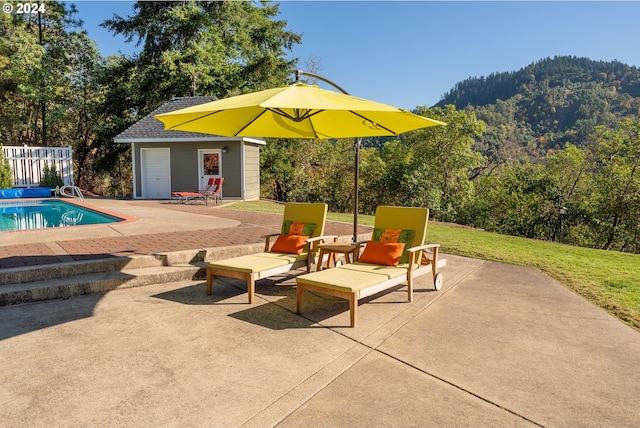 317 Aker Dr, Myrtle Creek, OR 97457 - view of patio with an outbuilding, an outdoor pool, and a storage structure