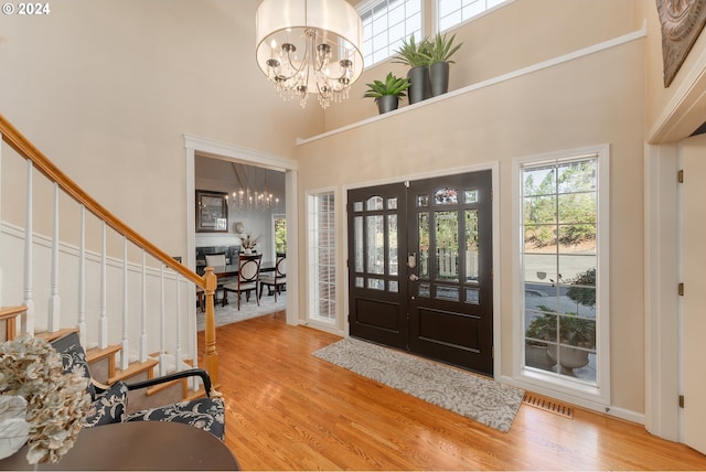 317 Aker Dr, Myrtle Creek, OR 97457 - foyer with a chandelier, a towering ceiling, wood finished floors, and stairs