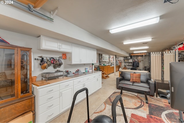 317 Aker Dr, Myrtle Creek, OR 97457 - kitchen featuring light countertops, white cabinetry, and open floor plan