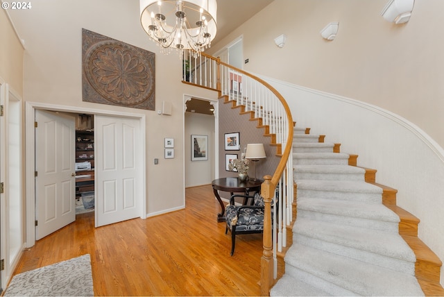 317 Aker Dr, Myrtle Creek, OR 97457 - staircase with a high ceiling, a chandelier, wood finished floors, and baseboards