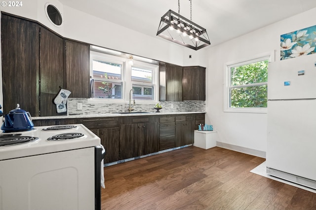 kitchen with hanging light fixtures, dark wood-type flooring, tasteful backsplash, white appliances, and sink