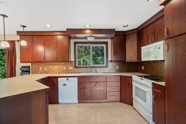 kitchen featuring decorative light fixtures, white appliances, light tile patterned floors, and sink