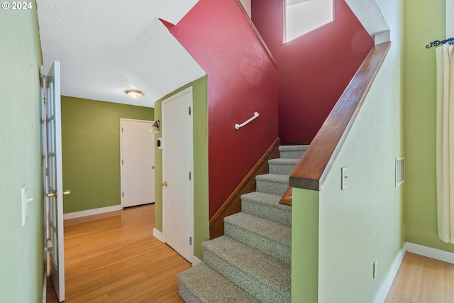 staircase featuring hardwood / wood-style floors