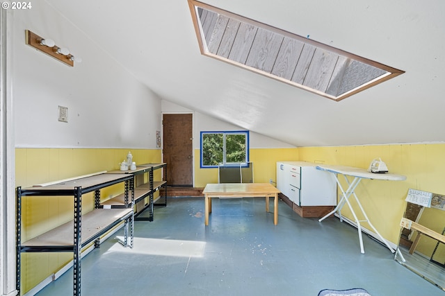 interior space with vaulted ceiling with skylight