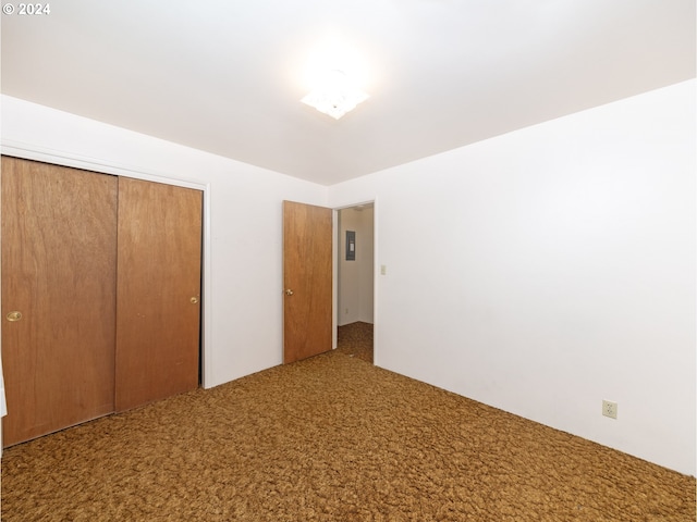 unfurnished bedroom with a closet and carpet flooring