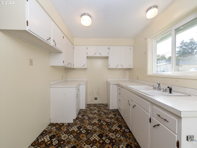 kitchen featuring sink and white cabinetry