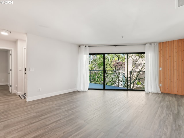 spare room with wood-type flooring