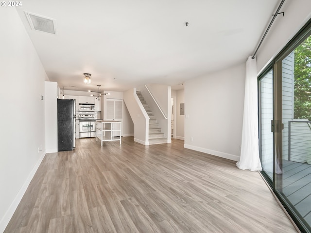 unfurnished living room featuring light hardwood / wood-style flooring