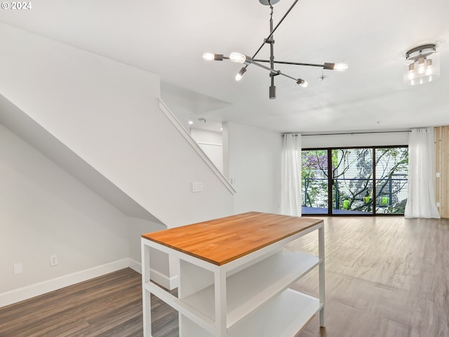 interior space with hanging light fixtures, dark hardwood / wood-style flooring, and a chandelier