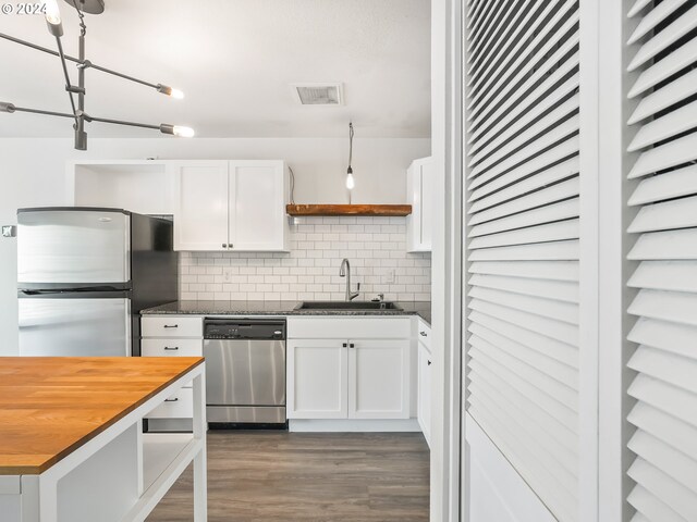 kitchen with sink, decorative backsplash, butcher block countertops, white cabinetry, and stainless steel appliances