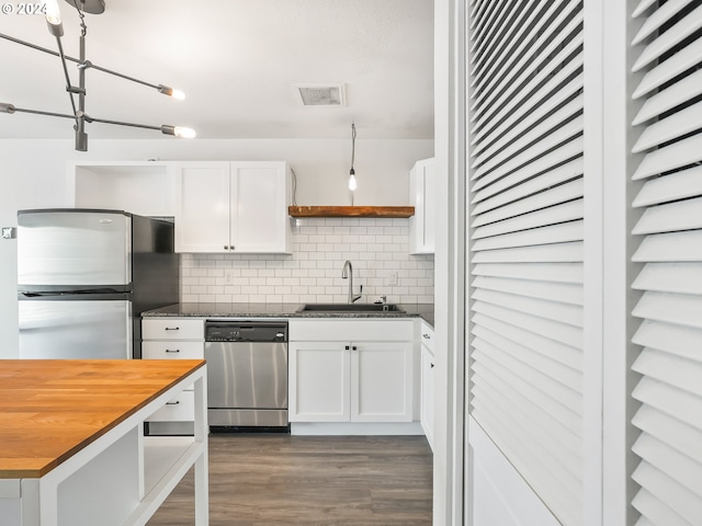 kitchen featuring wood counters, sink, white cabinetry, appliances with stainless steel finishes, and backsplash