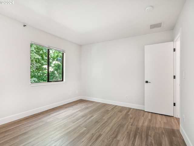 unfurnished room with light hardwood / wood-style flooring