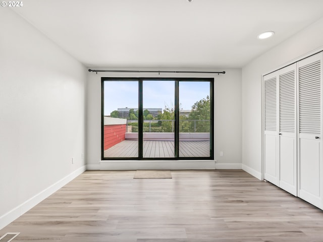 interior space featuring access to outside, a closet, and light hardwood / wood-style flooring