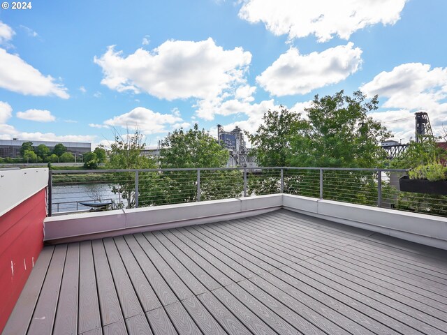 wooden deck featuring a water view