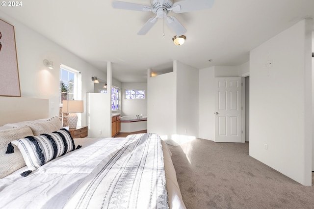 carpeted bedroom featuring ceiling fan and ensuite bath