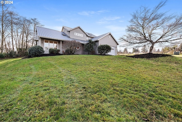 view of front of home with a garage and a front lawn