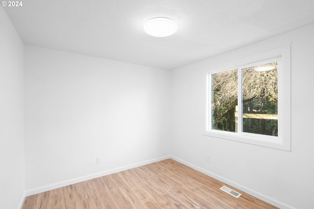 spare room with light hardwood / wood-style floors