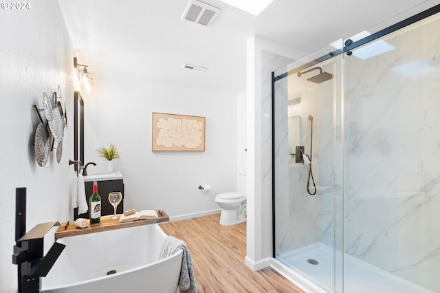 bathroom featuring wood-type flooring, toilet, and walk in shower