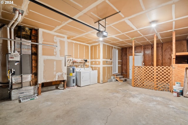 garage featuring washer and dryer, electric water heater, and a garage door opener