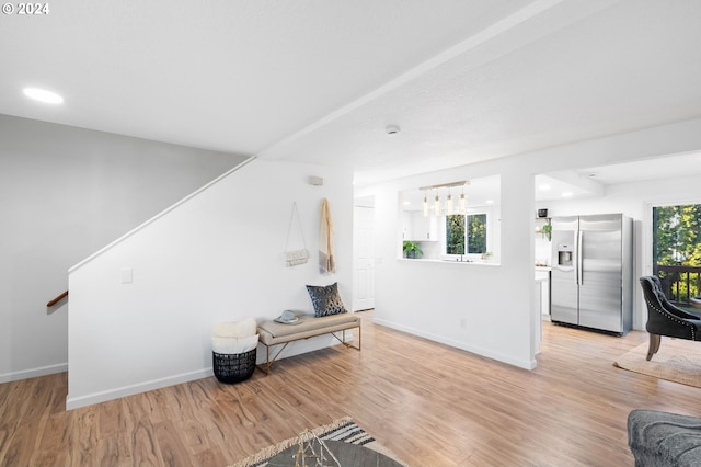 living room featuring plenty of natural light and light hardwood / wood-style flooring