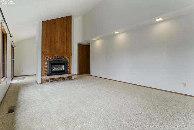 unfurnished living room with light carpet, a fireplace, visible vents, and baseboards