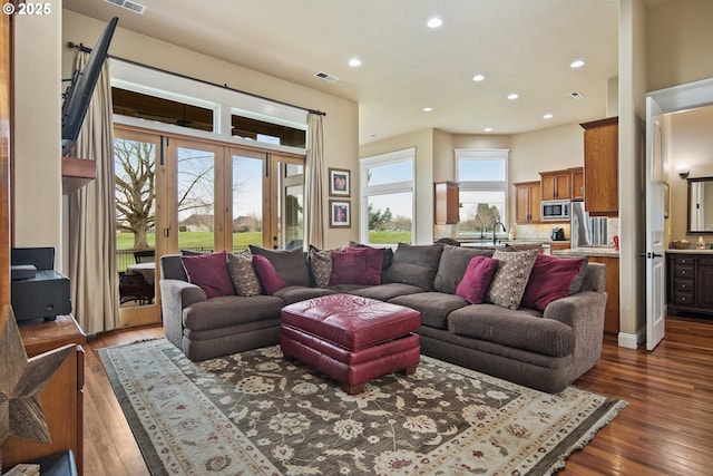 living room with french doors, wood finished floors, visible vents, and recessed lighting