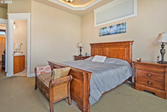 bedroom with light carpet and ensuite bath