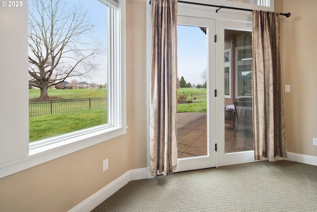 doorway with french doors, carpet flooring, and baseboards