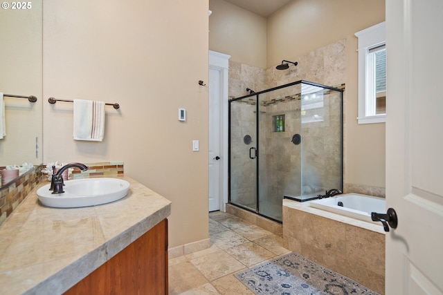 full bathroom featuring a bath, a stall shower, and vanity