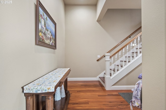 stairs featuring baseboards and wood finished floors