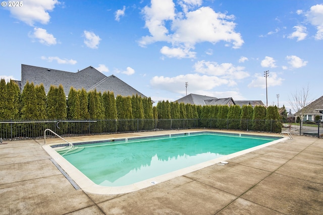 community pool featuring a patio and fence