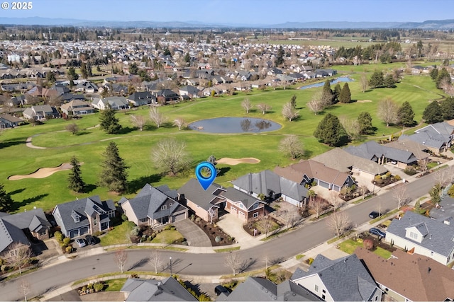 aerial view with a residential view, a water view, and golf course view