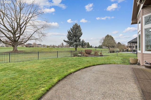 view of yard featuring a patio area, a fenced backyard, and a rural view