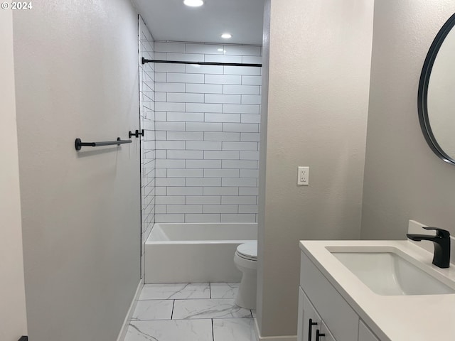 full bathroom featuring vanity, tiled shower / bath combo, and toilet