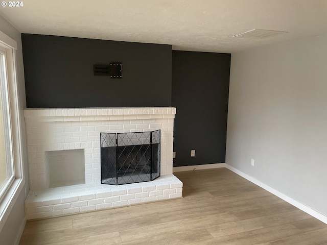 unfurnished living room with light hardwood / wood-style flooring and a fireplace