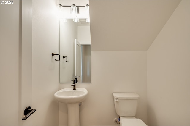 bathroom with vaulted ceiling and toilet