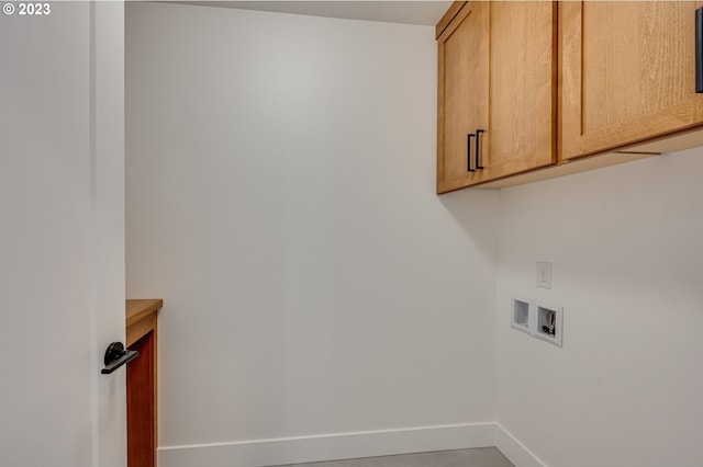 laundry room featuring hookup for a washing machine and cabinets