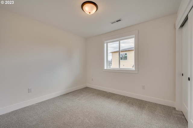 unfurnished bedroom with carpet floors and a closet